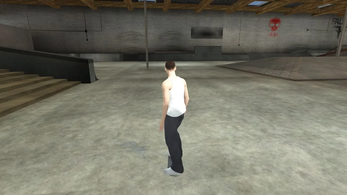 A skater in Cleanroom’s BlackBoxPark indoor skatepark, with stairs, rails and ramps.